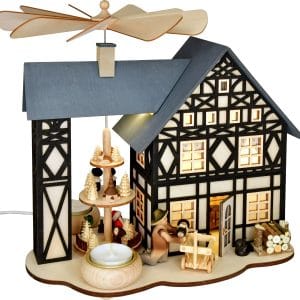 Christmas pyramid with half-timbered house design and wooden figurines.