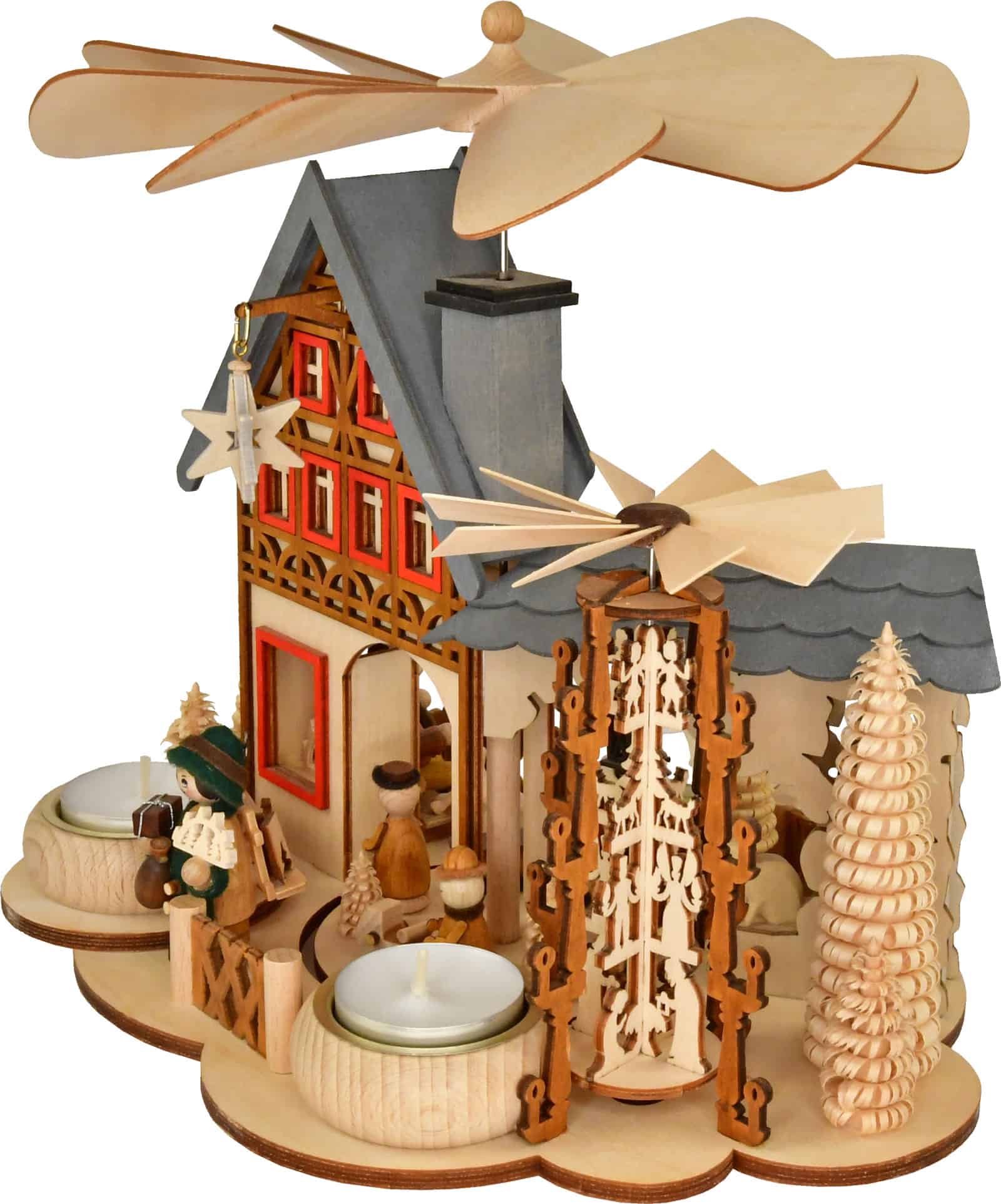 Decorative Christmas pyramid house with wooden figures and candles.